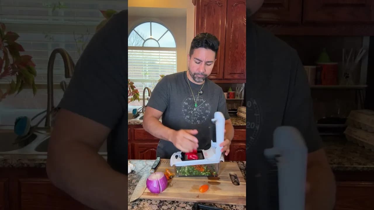 SuperZydan pressing a red pepper through the Fullstar vegetable chopper in his kitchen