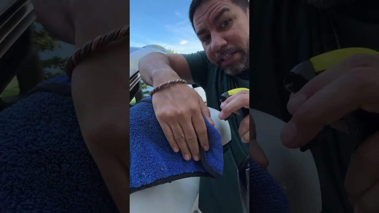 Wiping down a car with Meguiar's Ultimate Quik Detailer and a blue microfiber towel