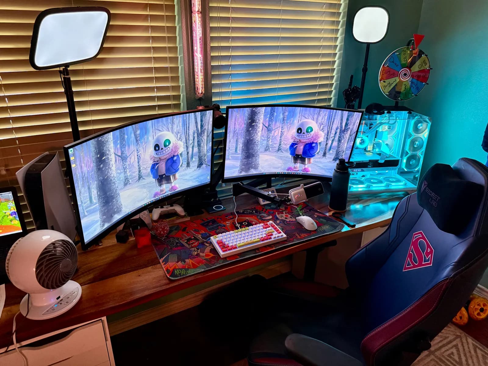 The full desk: two curved monitors, Elgato key lights, the white PC and a gaming chair