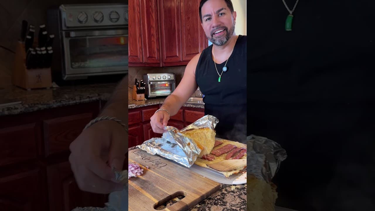 SuperZydan unwrapping a sandwich on a cutting board in his kitchen