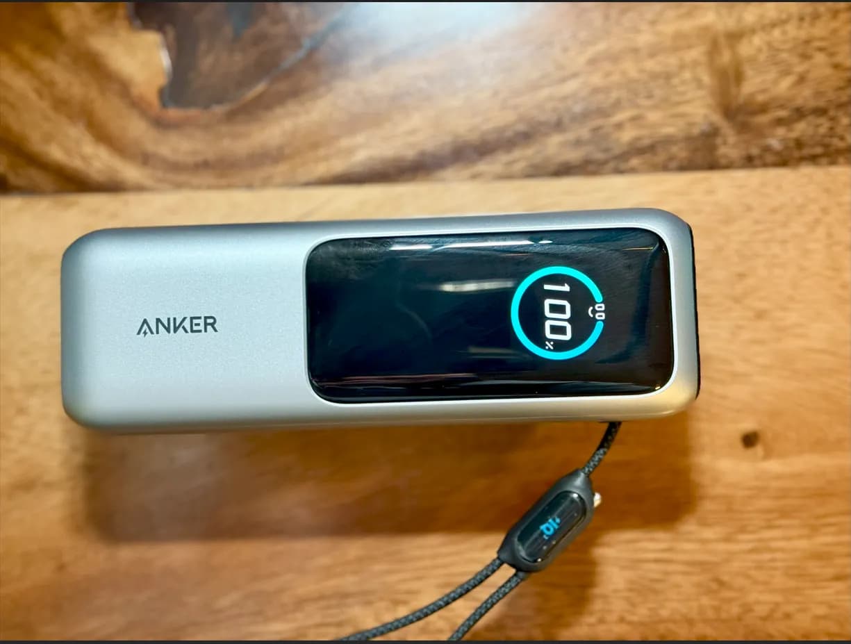 The Anker power bank's round display showing 100 percent